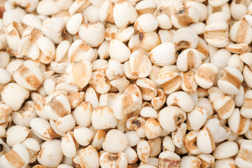 millet in a wooden bowl isolated on white