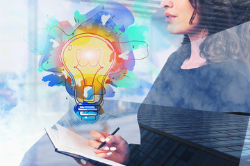 Woman with notebook in office and her bright idea