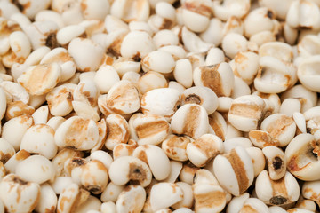 millet in a wooden bowl isolated on white