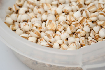 millet in a wooden bowl isolated on white