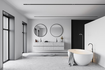 Tub and sink in white and black bathroom