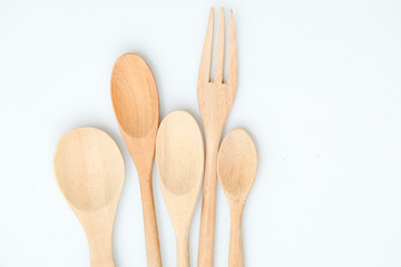 wooden spoon and fork on pastel color background