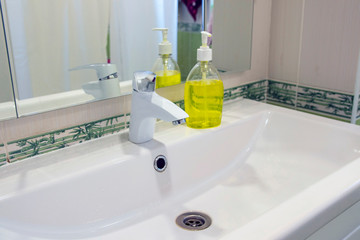 Washing hands man rinsing soap with running water at sink, Coronavirus prevention hand hygiene.
