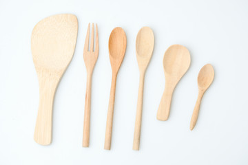 wooden spoon and fork on pastel color background