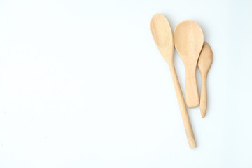 wooden spoon and fork on pastel color background