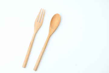 wooden spoon and fork on pastel color background