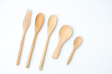 wooden spoon and fork on pastel color background