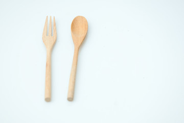 wooden spoon and fork on pastel color background