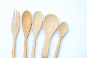 wooden spoon and fork on pastel color background