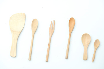 wooden spoon and fork on pastel color background