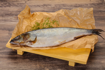 Salted herring over the wooden board