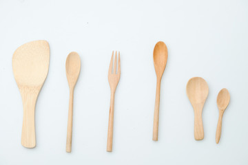 wooden spoon and fork on pastel color background