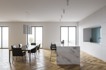 White and blue kitchen, bar and table, side view