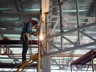 Welding work ,worker with protective welding metal on construction