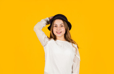 Ambitious and beautiful. Young and carefree. retro girl yellow background. happy kid retro hat. vintage fashion look. summer accessory collection. child long hair. beauty and style. happy childhood