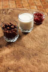 Yogurt with nuts on a wooden light background. Natural yogurt.