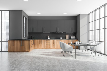 Gray and wooden kitchen interior with table