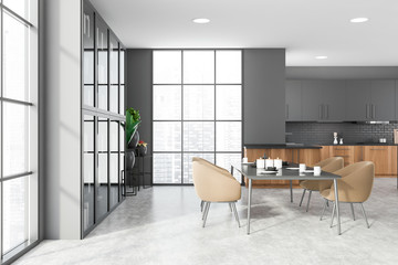 Gray and wood kitchen with table and bookcase