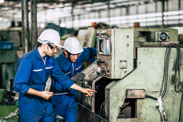 Factory machine maintenance service engineer team worker working together teamwork inspector in...