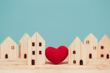 Love heart between two house wood model for stay at home for healthy community together concept. - obrazy, fototapety, plakaty