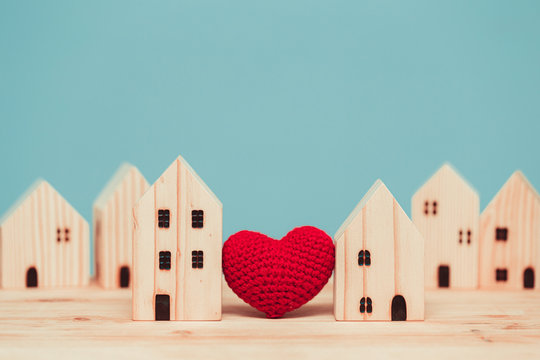 Love heart between two house wood model for stay at home for healthy community together concept.