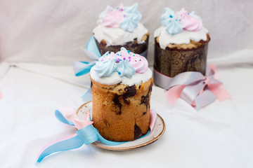 Traditional orthodox easter cake kulich with festive blue and pink decoration. White background, lot of copy space.