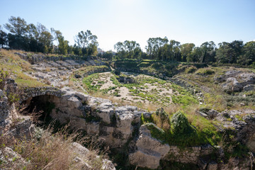 Fototapeta na wymiar Roman amphitheater. Archaeological Park of Neapolis, Syracuse, Sicily, Italy