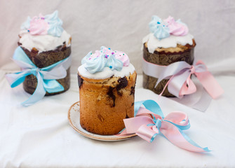 Traditional orthodox easter cake kulich with festive blue and pink decoration. White background, lot of copy space.