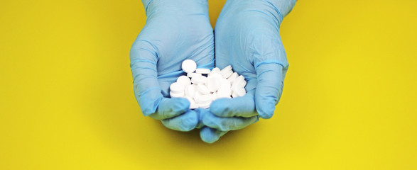 white pills and medicines in the hand