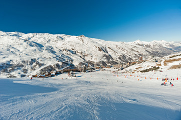 View of a ski piste in an alpine village ski resort