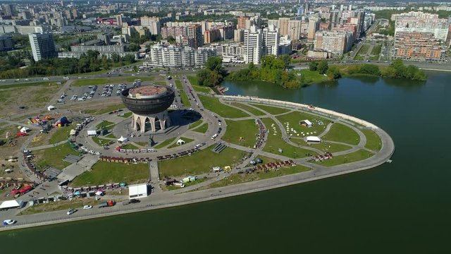 Helicopter beautiful cityscape Kazan city center epic modern district. Cauldron is main travel attraction. Residential new houses. Road traffic cars. Celebration bazaar fair. Aerial overall plan. 4k