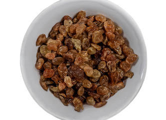 Raisins in a white plate isolated on a white background. Ingredient for desserts, pastries and sweet dishes. Close-up. View from above.