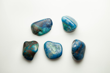 Blue shattuckite cabochon on the white background