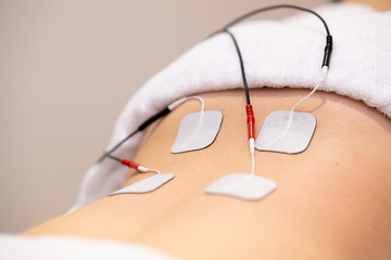 Electro stimulation in physical therapy to a young woman