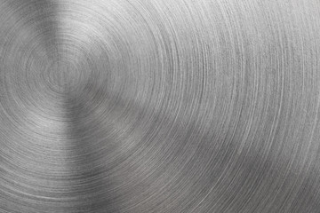 Abstract metal texture of brushed stainless steel plate with the reflection of light.