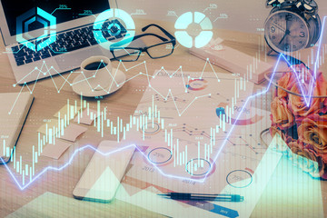 Financial graph colorful drawing and table with computer on background. Multi exposure. Concept of international markets.