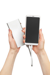 Woman's hands holding smartphone with powerbank. Isolated on white.
