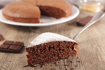 chocolate cake sliced on wood background