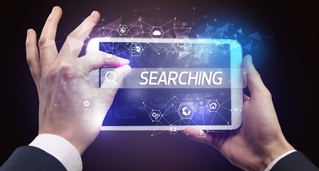 Close-up of a tablet searching FINTECH inscription, hi-tech computing concept