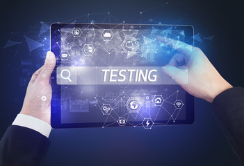 Close-up of a tablet searching TESTING inscription, hi-tech computing concept