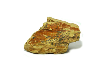 Shale stone isolated on white background. Shale is a sedimentary rock composed of very fine clay particles. Clay forms from the decomposition of the mineral feldspar.