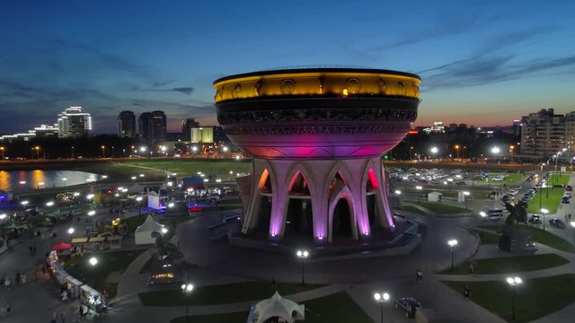 Aerial approach cauldron large epic copper boiler night illumination center of Kazan family. Attraction wedding palace. Best Russia cityscape skyline. People walk. Observation deck embankment