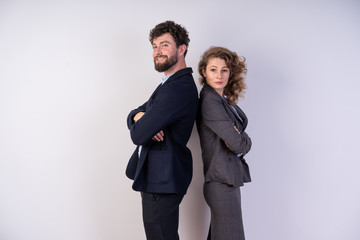 Business man and woman stand side by side. put she her hands and confidently look forward to the professionals