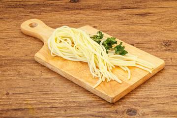 Chechil spaghetti cheese over board