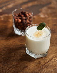 Yogurt with nuts on a wooden light background. Natural yogurt. View from above. Summer food.