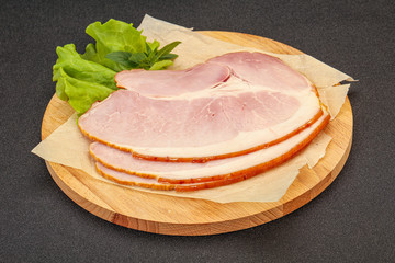 Sliced pork belly over board