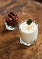 Yogurt with nuts on a wooden light background. Natural yogurt. View from above. Summer food.