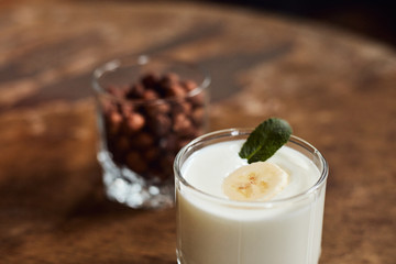 Yogurt with nuts on a wooden light background. Natural yogurt. View from above. Summer food.