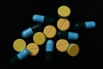 Pill and drug on black background