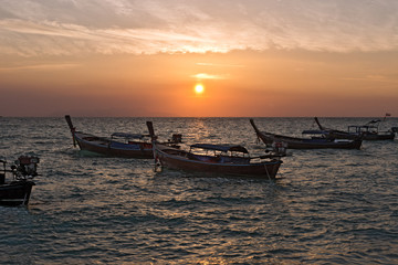 Fototapeta na wymiar Boats while Sunrise at Sunrise Beach, Koh Lipe, Thailand, Asia